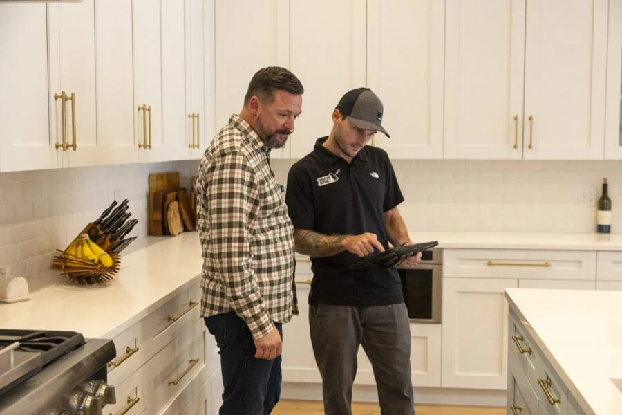 members of the Bright Side Painting team discussing painting options in a kitchen