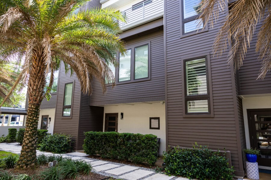 entry area of a townhome with fresh brown paint on the siding and white accents paint
