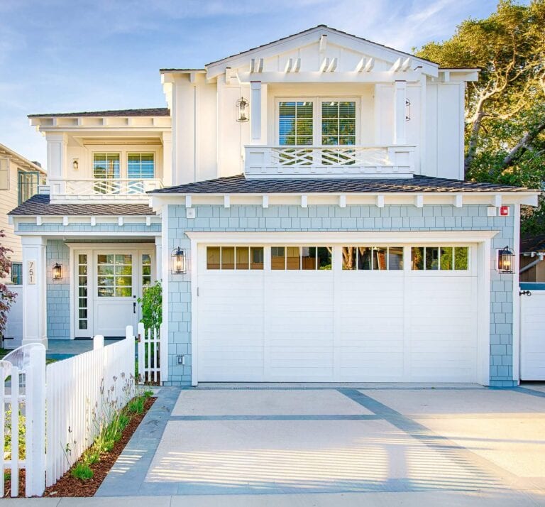 Front-facing exterior view of a blue beach house