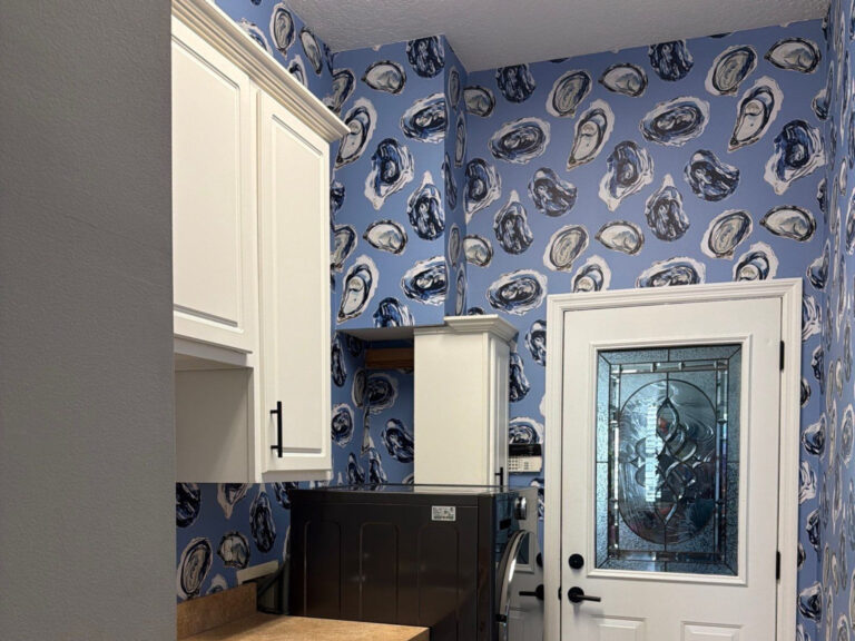 cabinets and new oyster themed wallpaper in laundry room