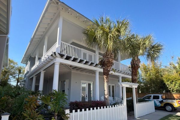 exterior of two story coastal house featuring updated stucco paint job