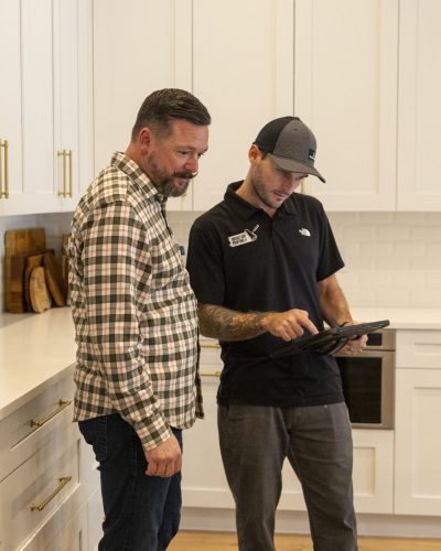 members of the Bright Side Painting team discussing painting options in a kitchen