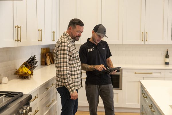 members of the Bright Side Painting team discussing painting options in a kitchen