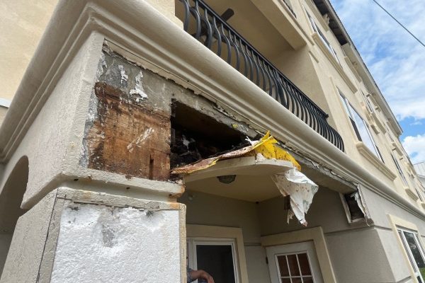 A deteriorating stucco building entrance.